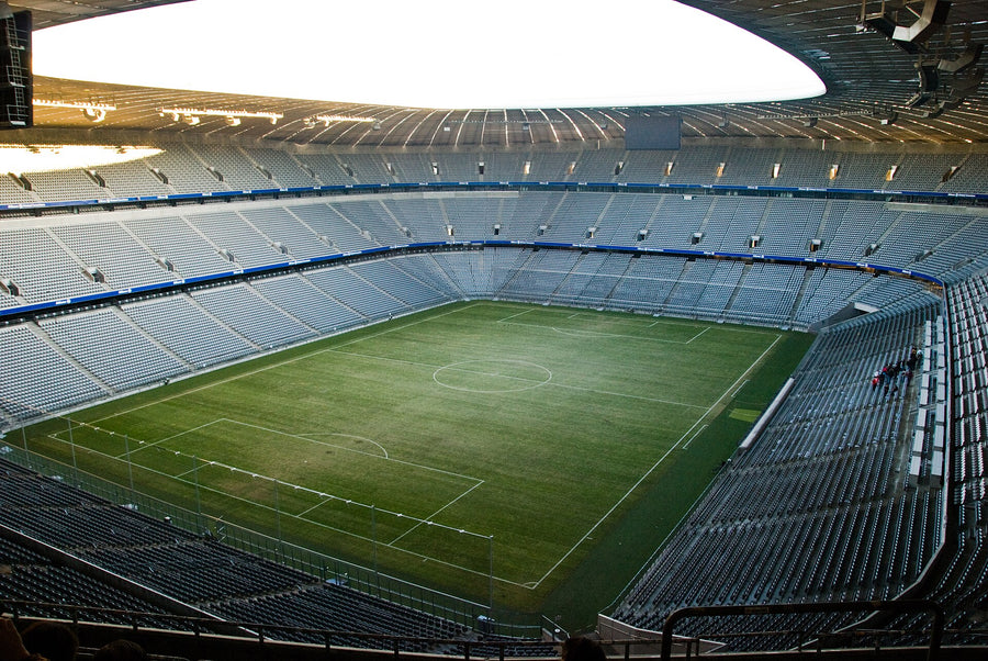 Elevated view from the upper tier behind the goal of the Allianz Arena along the full length of the field